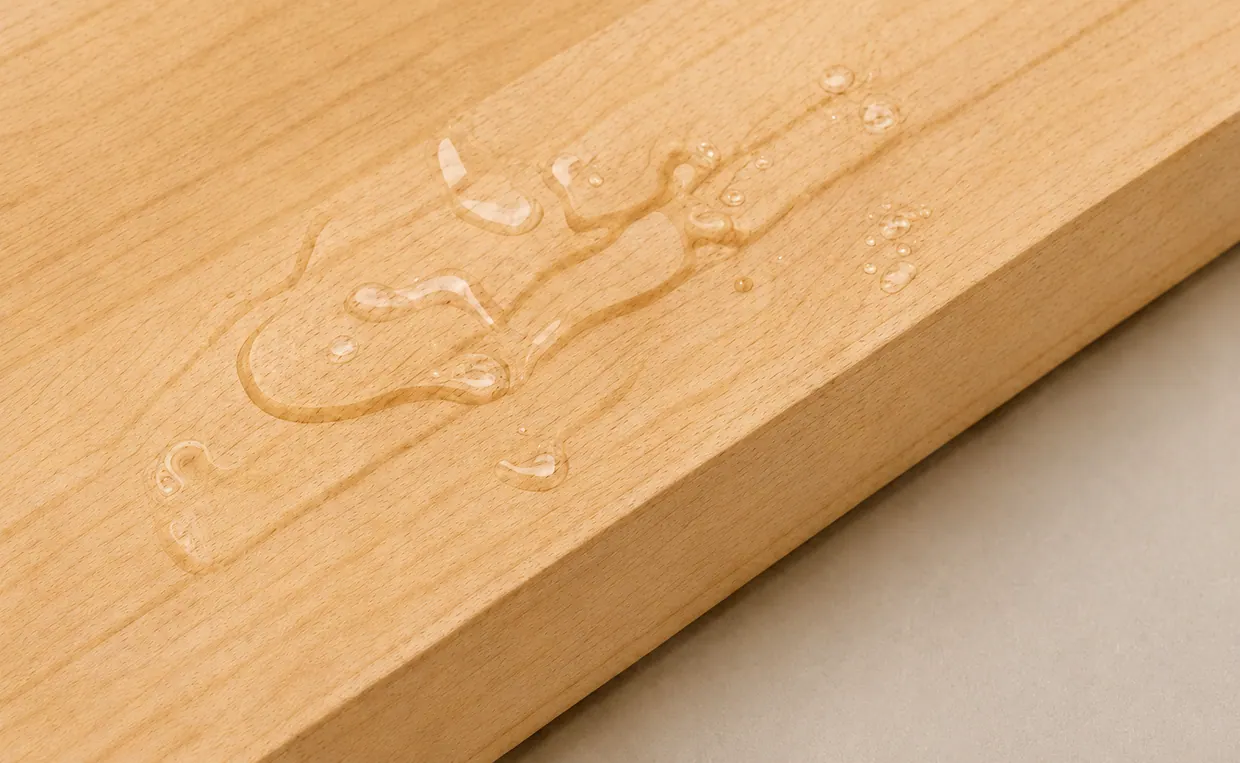 Water beading on the sealed wooden surface